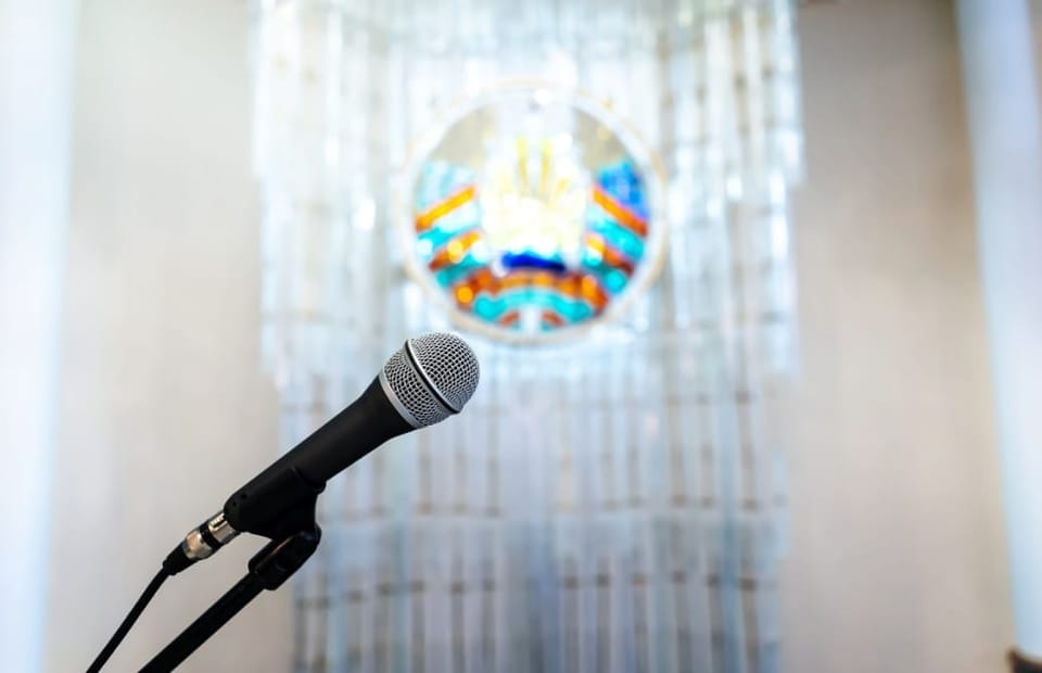 a microphone on a stand in front of a stained glass window